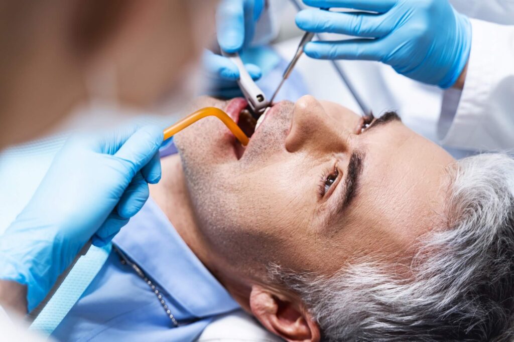 Smiling man receiving a root canal