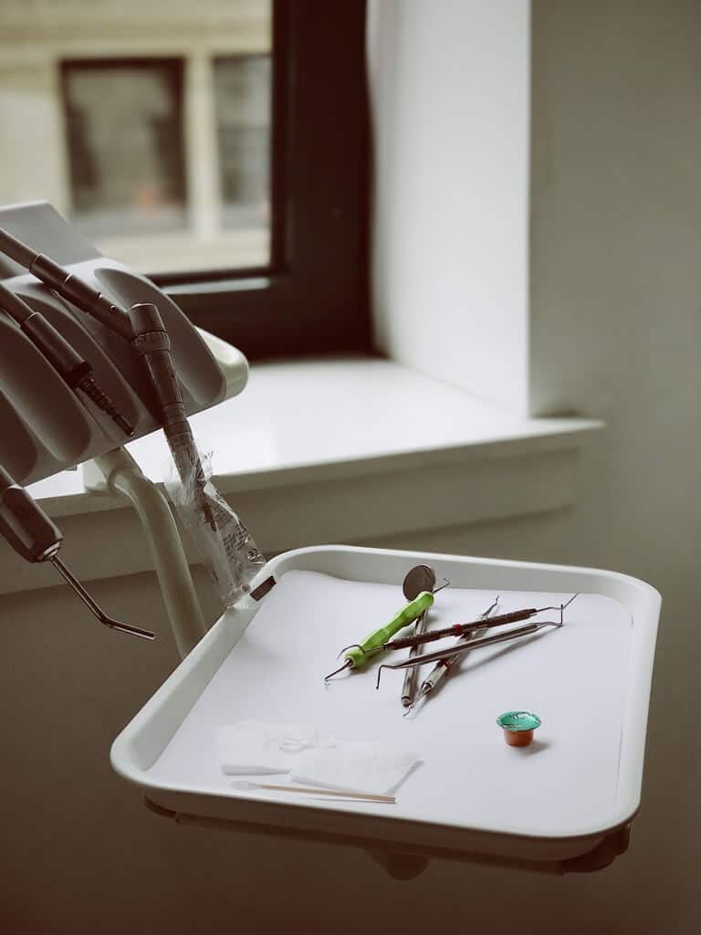 Close-up of oral surgery instruments on a white tray