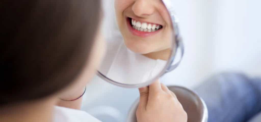 adult smiling with confidence showing teeth overjet correction